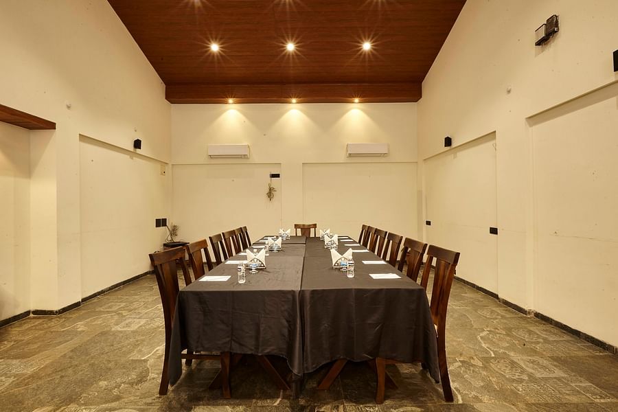 Indoor dining room with chairs and tables set up for a formal or business event - Mastiff Grand La Villae Resort, Lonavala