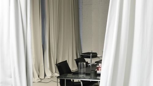 Conference room with meeting table surrounded by curtains