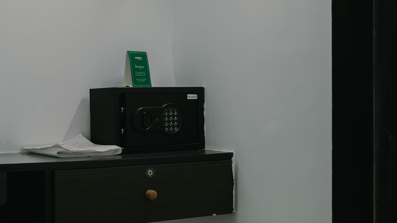 Minimalist closet space with a safety box in the Three BHK Deluxe Villa at Richmonde Ananta Elite, Goa.