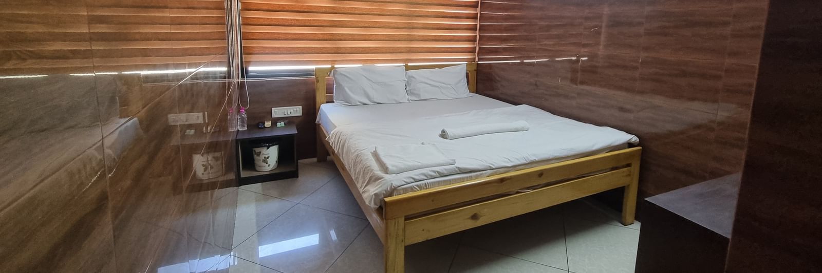 Corner view of the Double Bed Room With Air-conditioning featuring a double bed in the side.