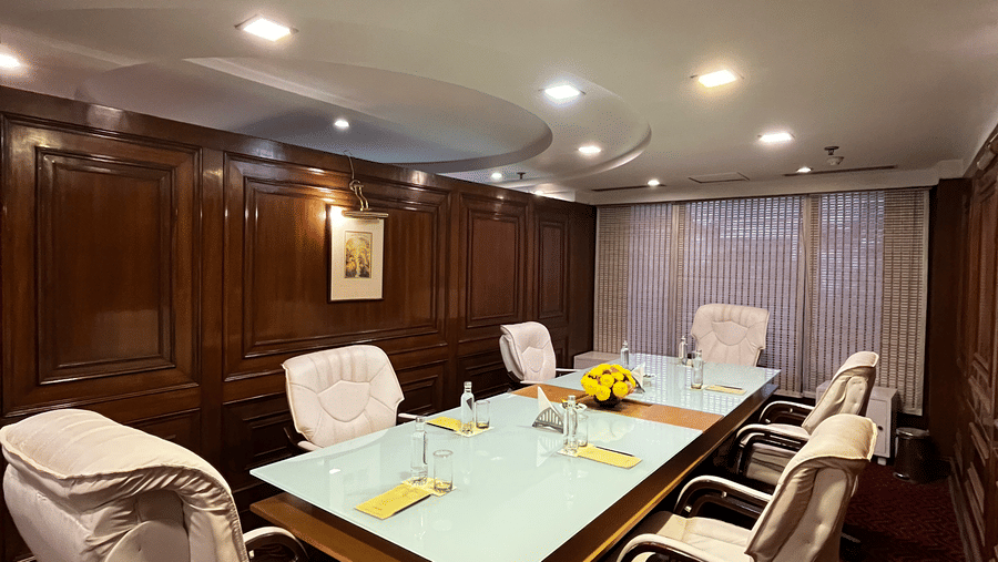 A meeting room at The Bristol Hotel, Gurgaon featuring a conference table surrounded by six chairs