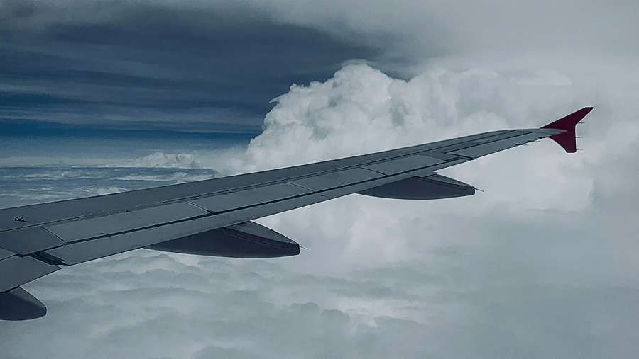 Wing of a flight from Chennai to Goa mid-air featuring clouds