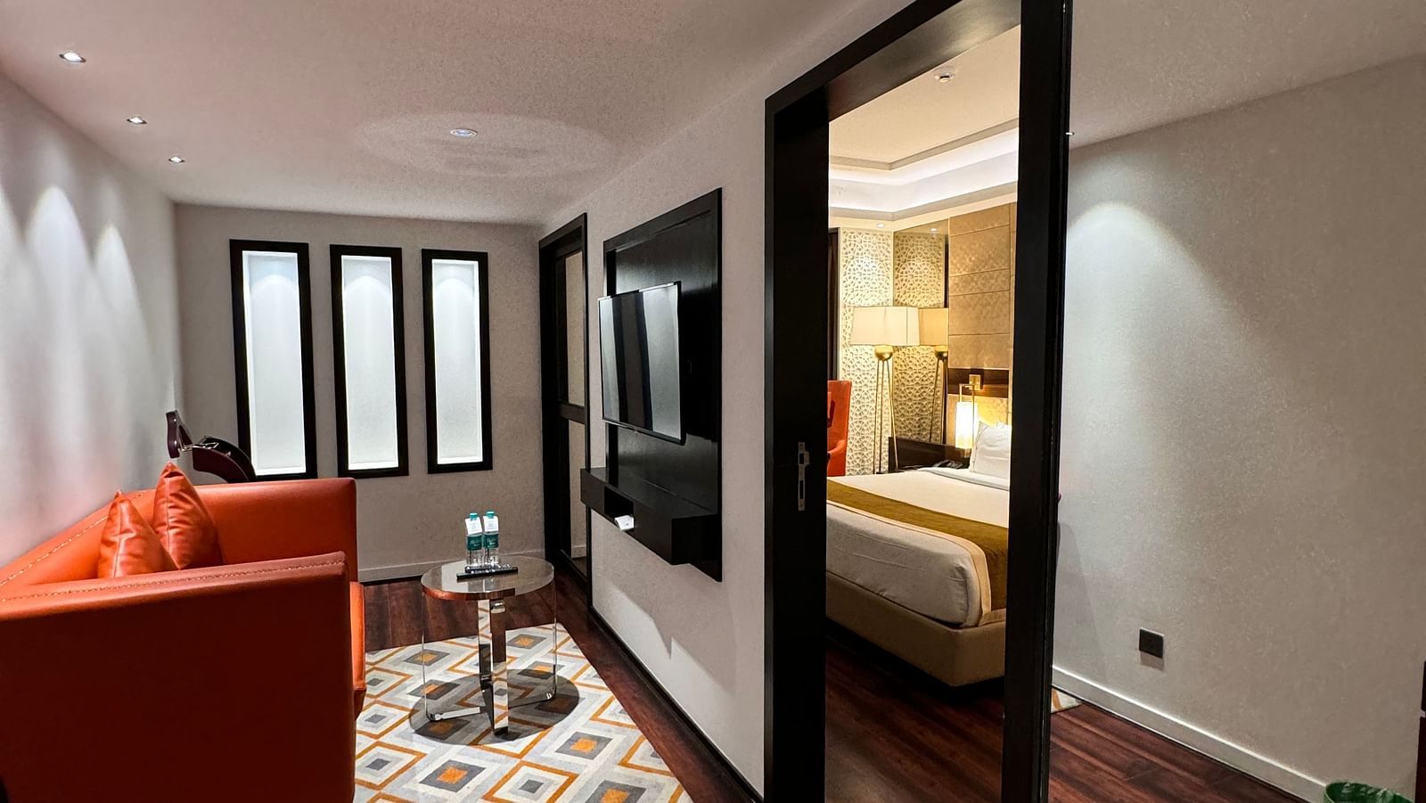 A living space with wooden flooring and comfortable seating at Cenneys Gateway.