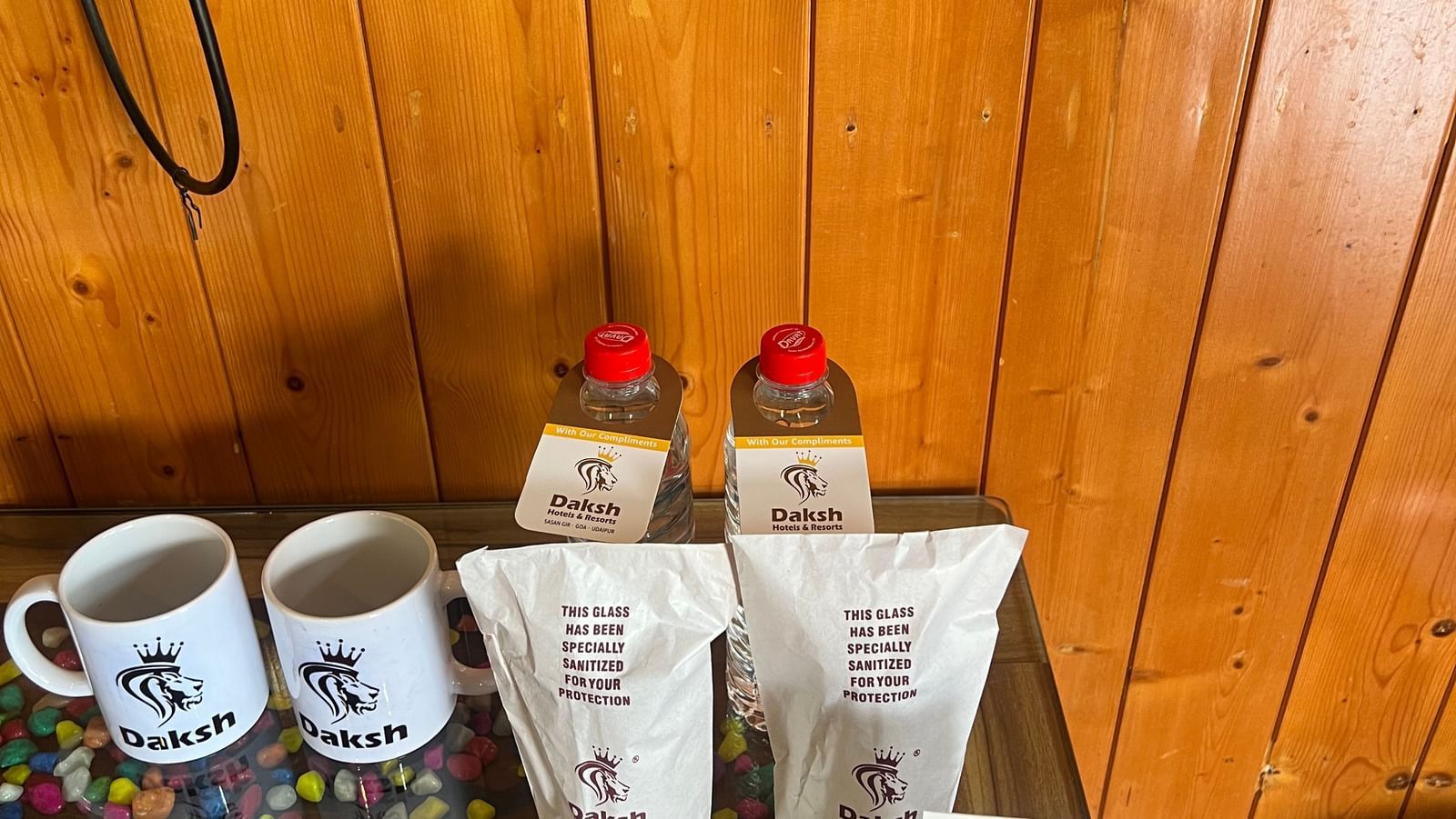 Tea and coffee making amenities placed on a surface in the Daksh Elite Cottage at Daksh The Valley Resort, Saputara.