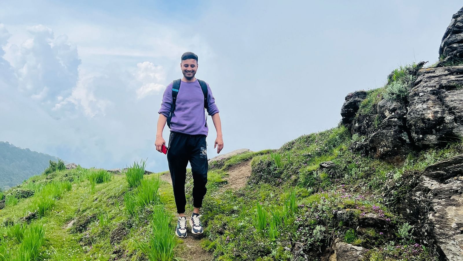 Image of a man walking through a trail in Garson Meadow | Faraway Cottages, Auli