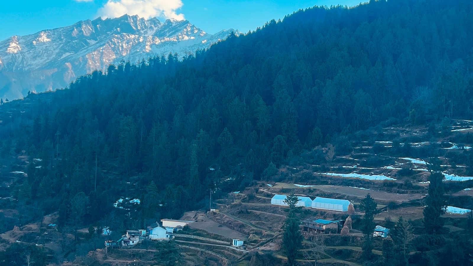 Aerial view of a village with mountians in the background | Faraway Cottages, Auli