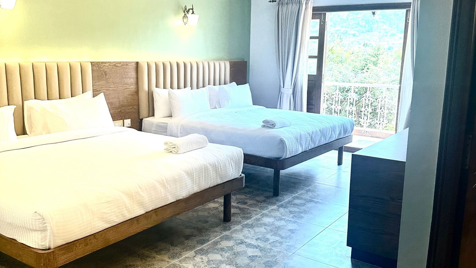 two double beds in one of the Heritage Suites at Summer House, Nandi Hills
