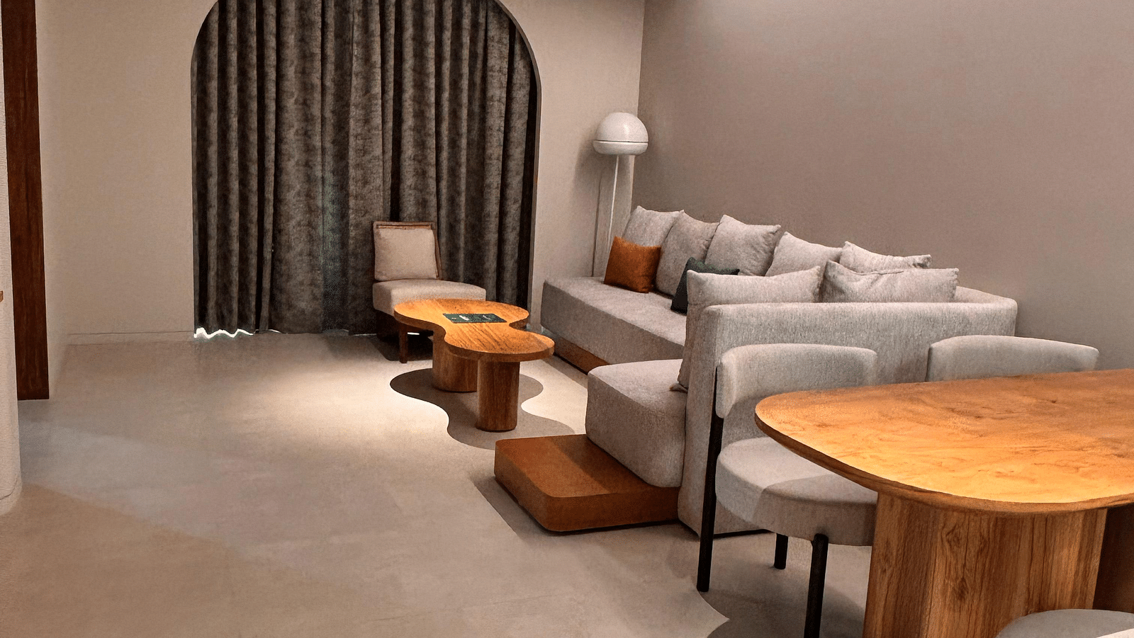 A partial view of a living area at Swosti Premium Beach Resorts, Puri, with a table and chairs.