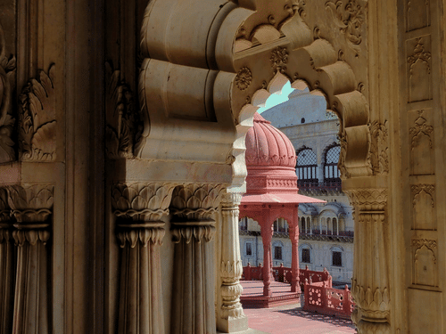 A view from inside a fort of the red cenotaph of Moosi Maharani Ki Chhatri