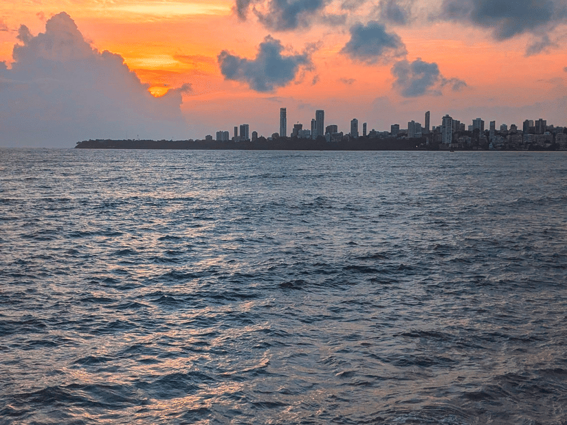 A view of the sunset from Marine Drive with the Arabian Sea in the foreground and different hues in the sky in the background