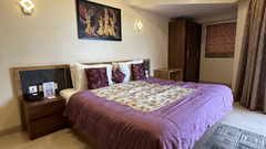 Double bedroom with bedside table, storage, and ceiling lights at VITS Kamats Resort, Silvassa