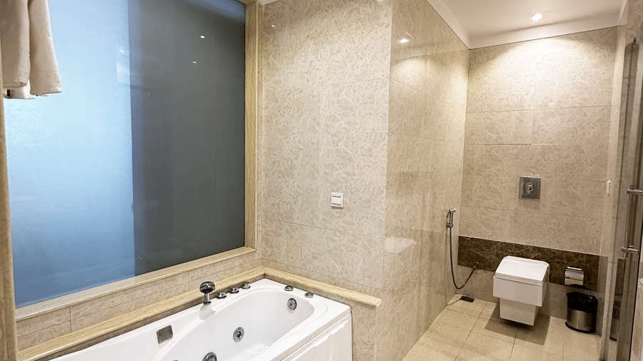 Jaccuzi in the Suite at Golden Tulip Jaipur, Kukas, placed in one corner of the well-lit bathroom, with a western commode on the other.
