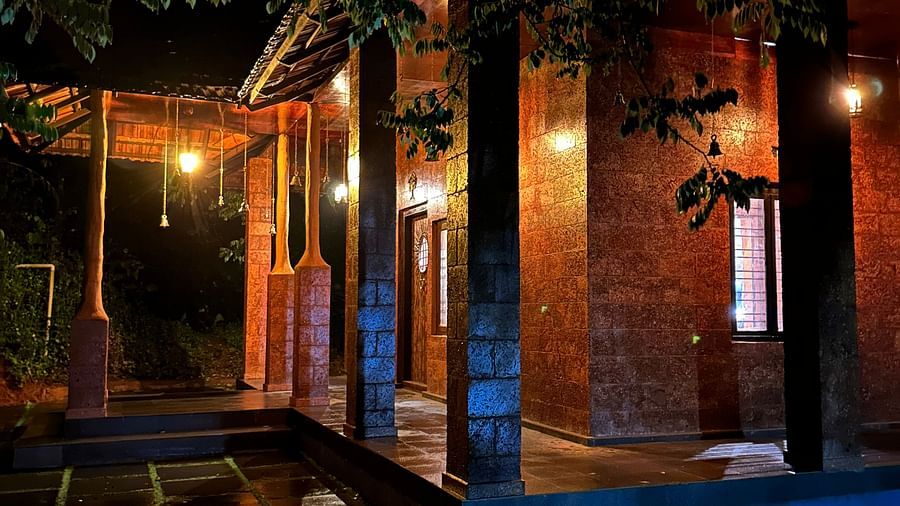 facade view of a stone building in the night - Holistic Stay Eco Resort, Kannur