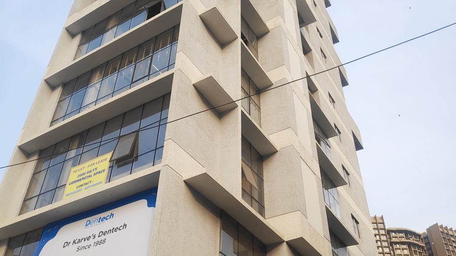 facade images of Maxxvalue Hotel, Chitranjan Tower, Powai, showcasing the concrete building from a lower angle2