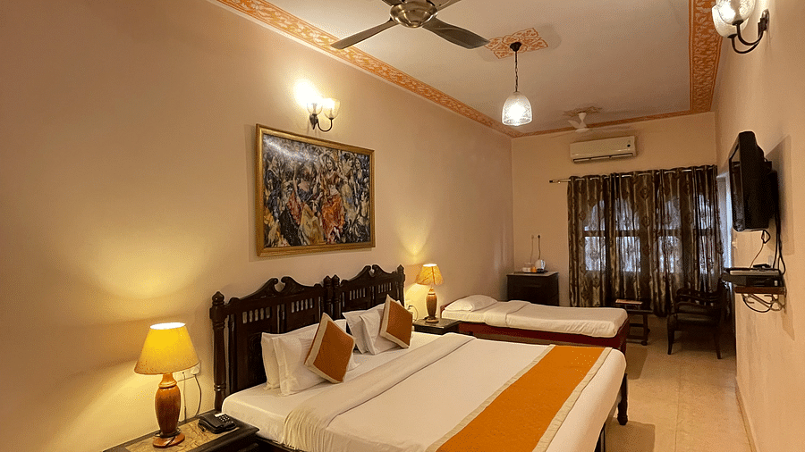 A double and a single bed in the Deluxe triple room at Suryaa Villa Jaipur