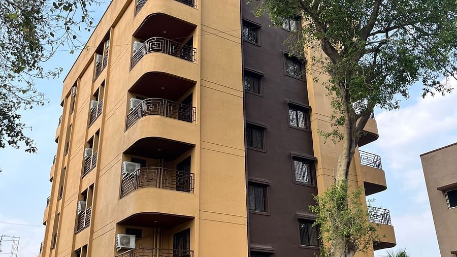 A facade image of a building with a large tree in front at VITS Select Kharadi, Pune.