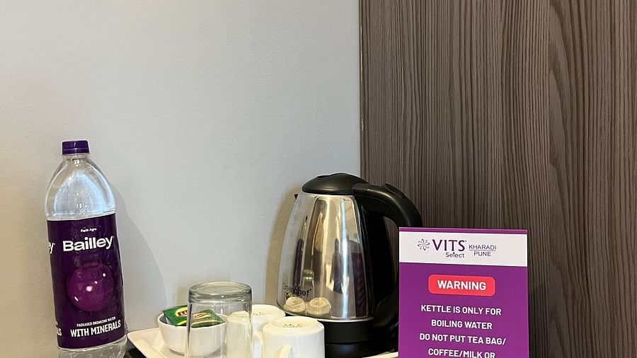 A shot of a kettle and tea cups placed on a wooden table at VITS Select Kharadi, Pune.