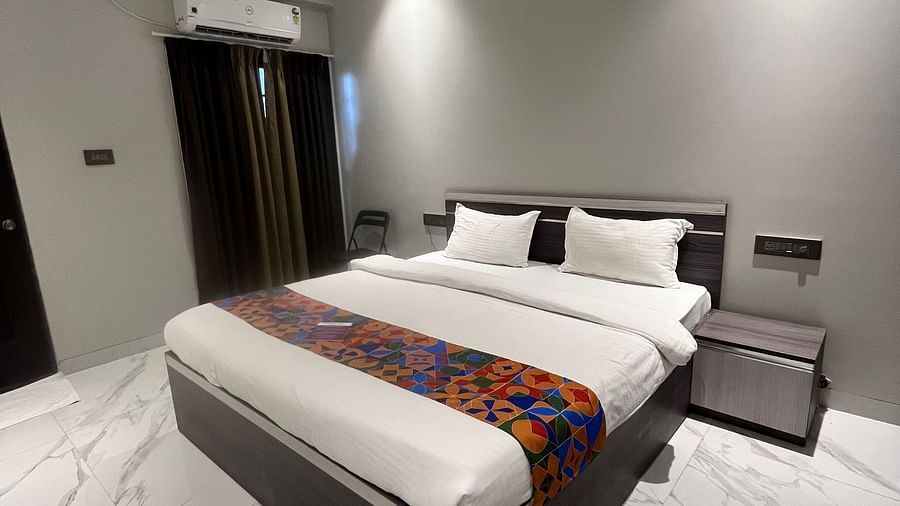 An image of the hotel bedroom with a large bed under a ceiling fan at VITS Select Kharadi, Pune.