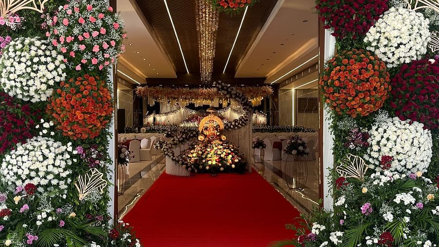 Elegant wedding stage with floral arrangements and drapes  | VRR Astoria Hotel and Conventional Centre