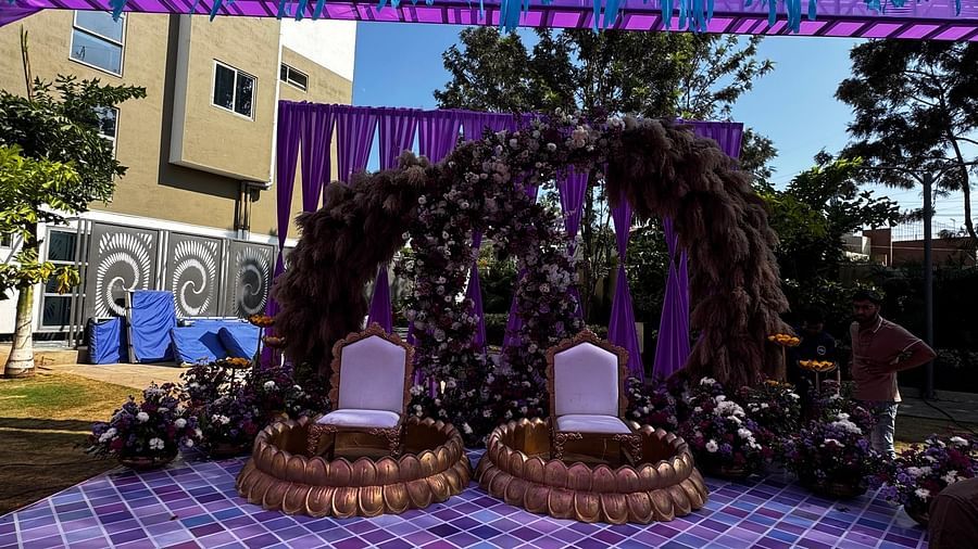 Vibrant purple and blue hanging decorations with floral arrangement on stage at VRR Astoria Hotel and Convention Centre