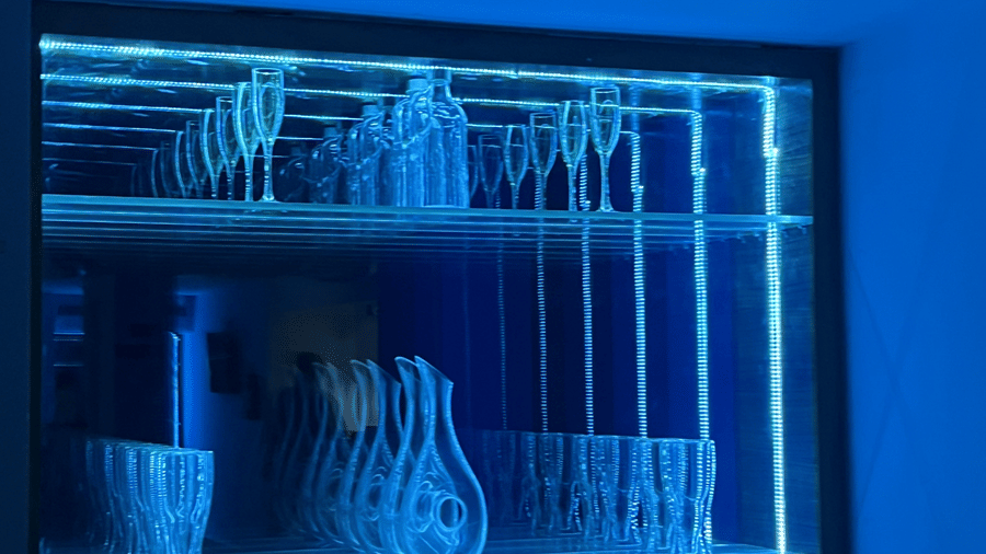 Illuminated beverage display inside the bar at Alps Residency, Krishnagiri.