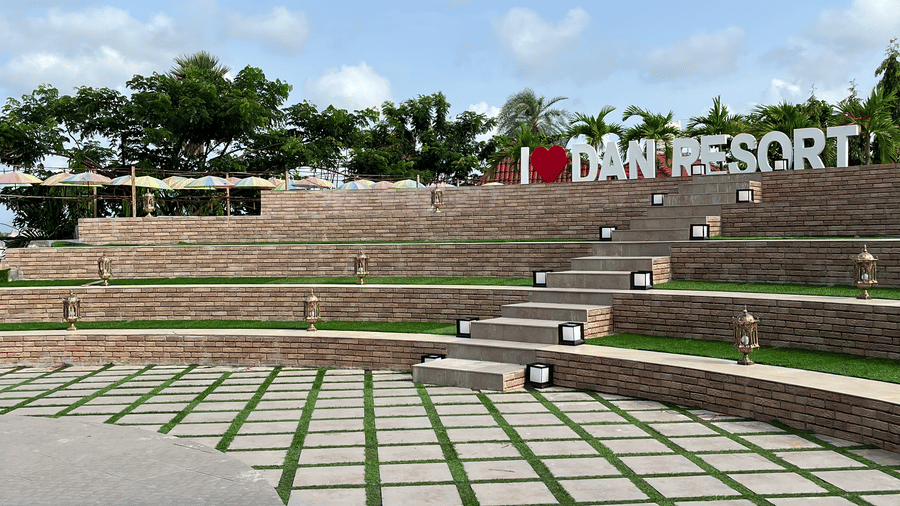 Close-up of the outdoor amphitheatre seating area under a clear blue sky - DAN Resorts & Weddings, Palghar
