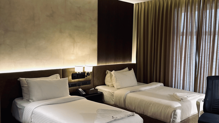 A set of 2 single beds with 2 pillows kept on each in the Executive Room at F Hotels, Bengaluru.
