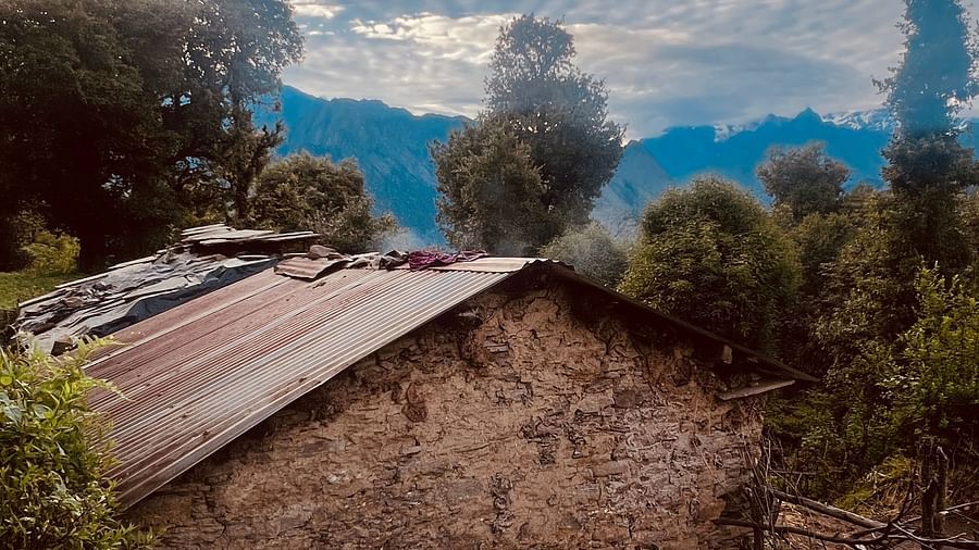 Image of stonewood house with scattered clouds in the background | Faraway Cottages, Auli