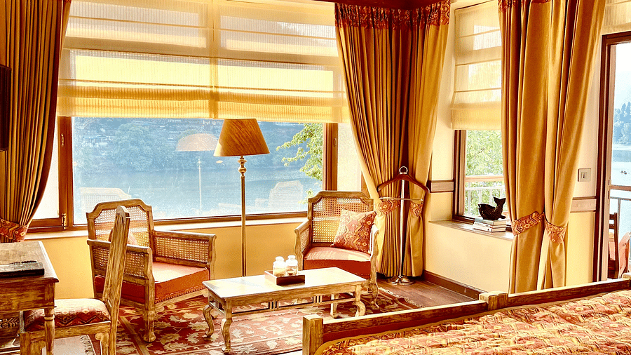 Superior Lake Facing Room seating area at Fishermen's Lodge, Bhimtal, showcasing royal decor, beautiful views, and a cozy sitting space.
