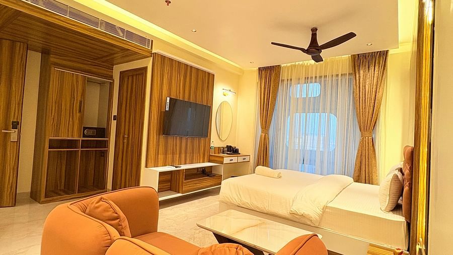 A shot taken from behind the sofa, showcasing the spacious room at Hotel Mumbai House, Vashi.