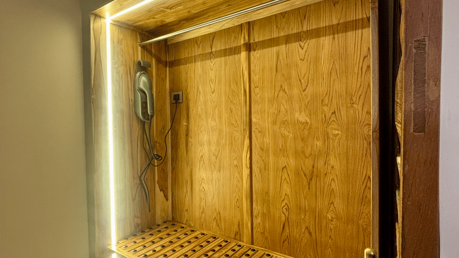 Walk-in Wardrobe at Vana Junior Suite featuring several sections with light fixtures and an electronic item is attached to the wardrobe.