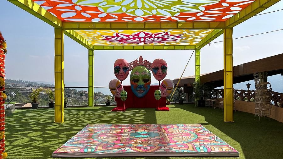 An intricately decorated mandap with floral designs and sheer fabric, set up outdoors on a patterned carpet, ready for a wedding ceremony - The Grand Legacy Resort and Spa
