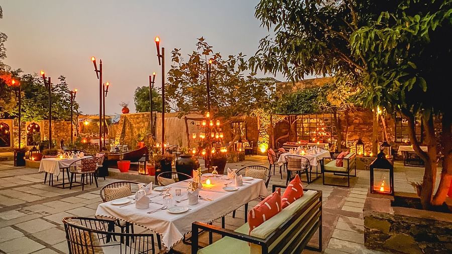 An image of an outdoor seating at the hotel with decorative lighting - Utsav Camp Sariska