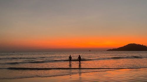 The wide view of a beach during the time of sunset.