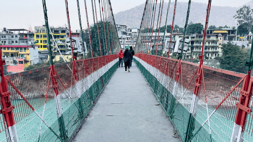 People walking on Ram Jhula, one of the must-visit places in Rishikesh