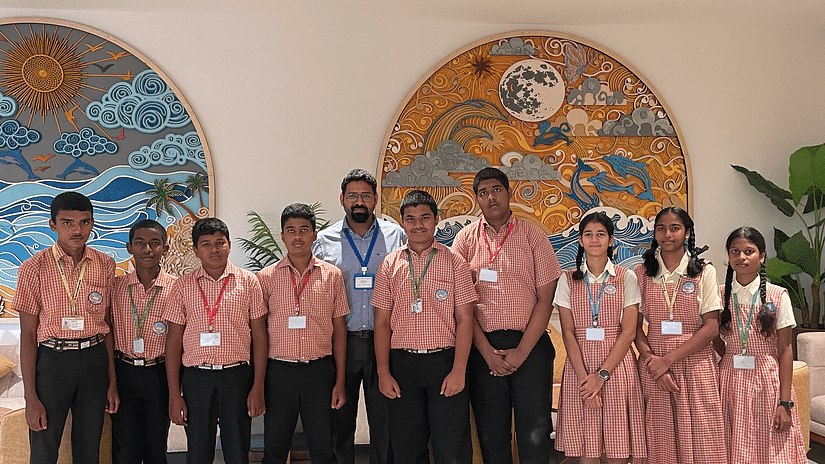 A group of students posing for a picture inside a hall