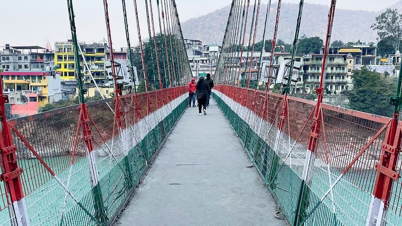 People walking on Ram Jhula, one of the must-visit places in Rishikesh