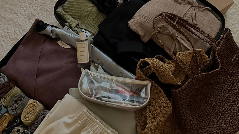 Open luggage bag packed with clothes and accessories.