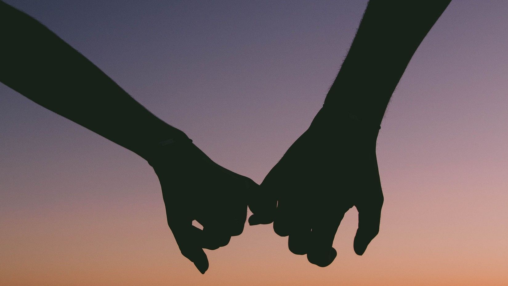 Couple holding hands during the sunset in Goa near the beach