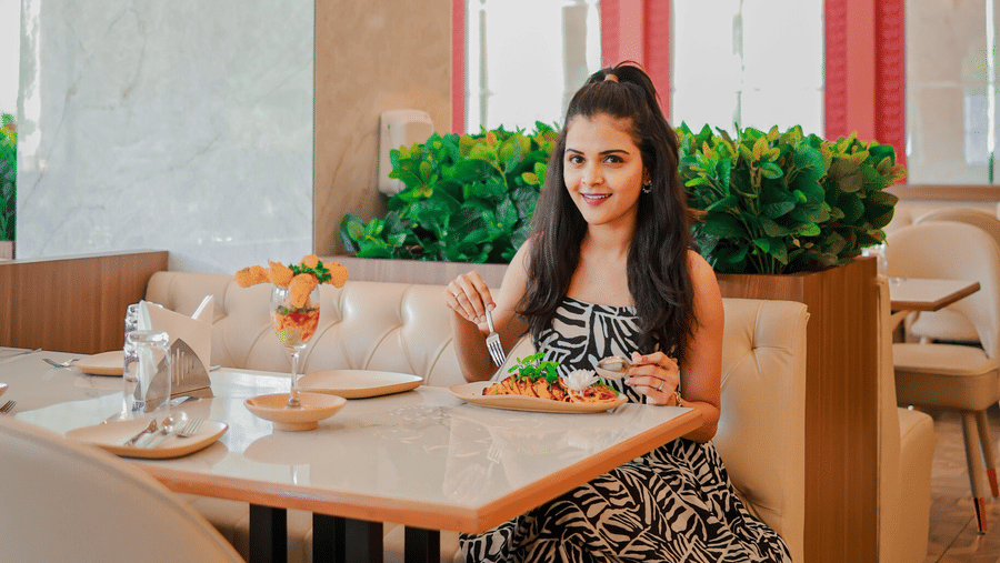 Guest seated in the dining area at Hotel Mumbai House Digha, Airoli.