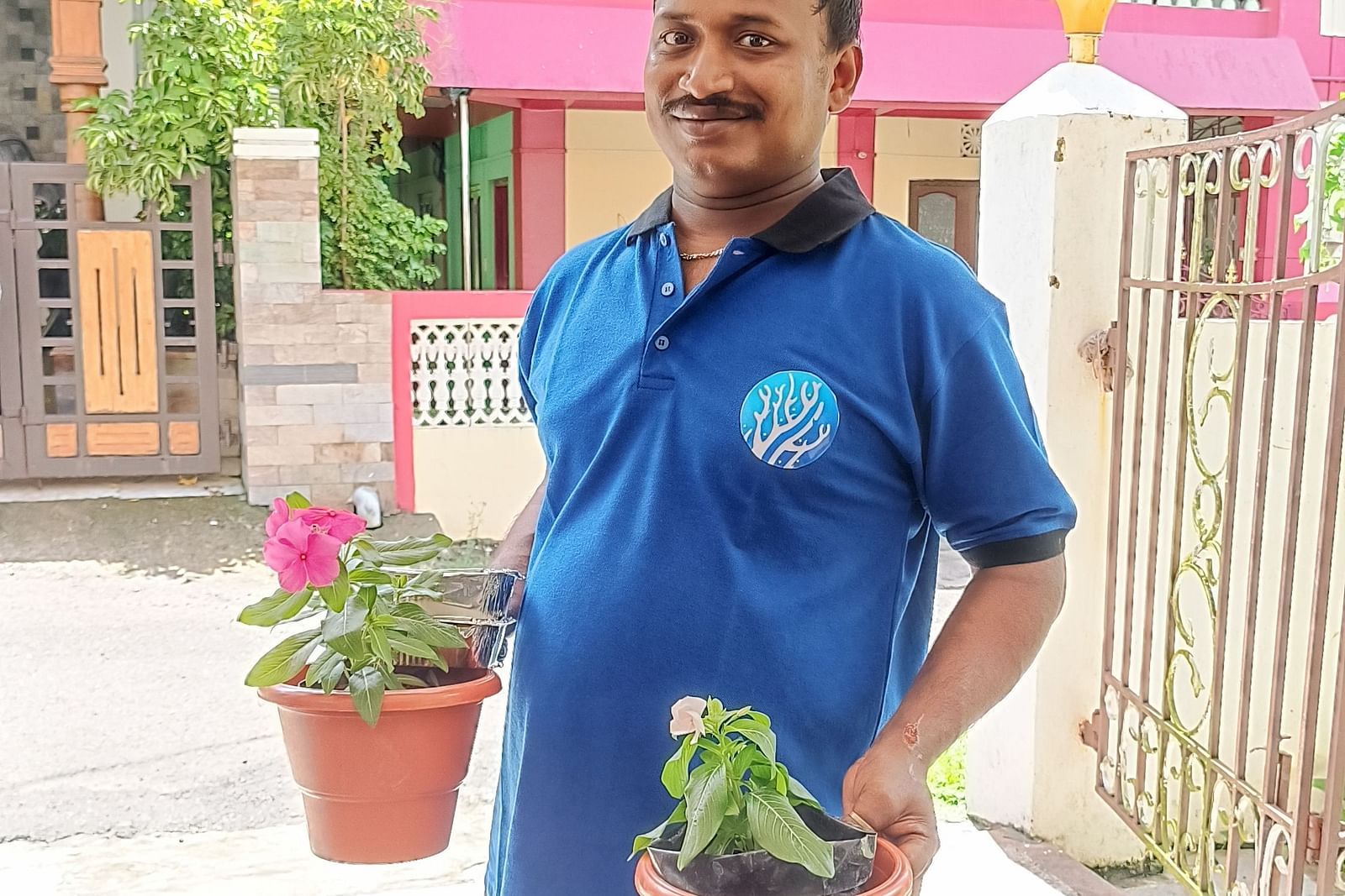 A man holding two pots at Coral Reef Hotel & Resort
