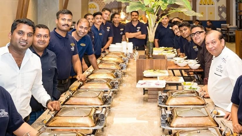 an image of chefs and other employees posing for a picture while displaying foods at Cloud9 Sarovar Premiere, Palolem Goa