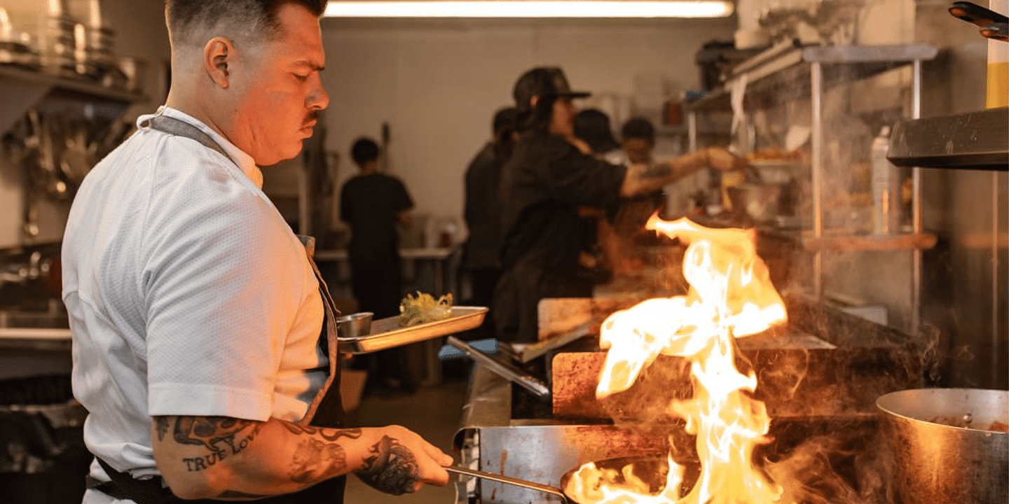 A chef cooking in a commercial kitchen