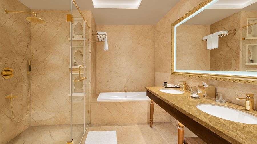 Marble bathroom featuring a walk-in shower and premium toiletries on the vanity - Kaldan Samudhra