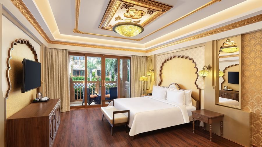An elegant bedroom with a canopy-styled headboard and artistic wall panelling – Kaldan Samudra, one of the finest Mahabalipuram resorts with private beach
