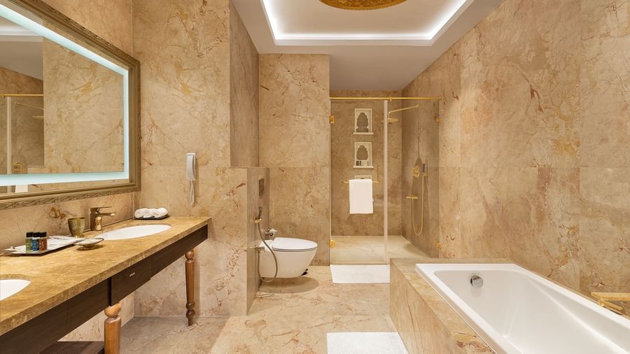 A lavish marble bathroom with a modern bathtub and double sink vanity counter - Kaldan Samudhra