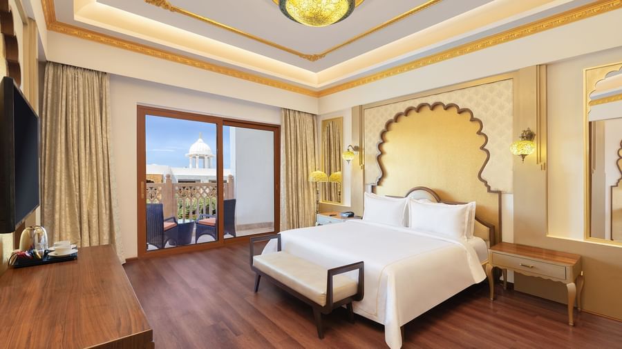 Spacious bedroom featuring crisp white linens and wide windows overlooking scenic views – Kaldan Samudra, one of the top resorts near Mahabalipuram