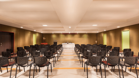 A view of the banquet hall of with black chairs at Regency Tuticorin by GRT Hotels.