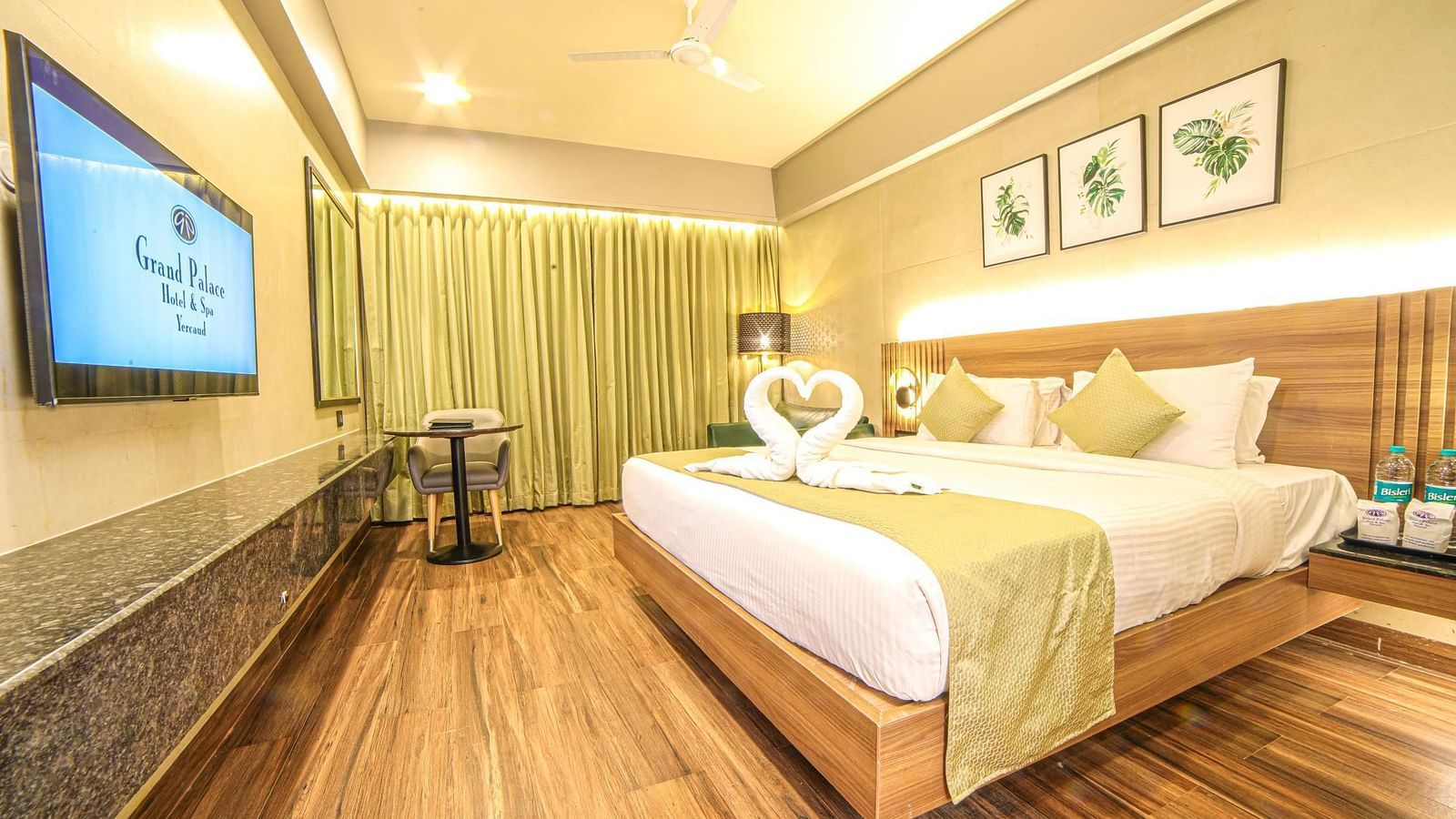 Side view of the double bed and a TV in the Sunrise Room at Grand Palace, Yercaud