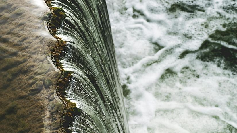 Top view of a waterfall with clear water flowing into a bigger water body - The Dukes Retreat, Khandala
